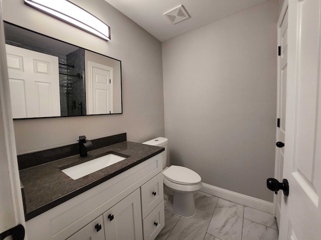 bathroom with vanity, toilet, and walk in shower