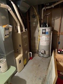 utility room featuring gas water heater