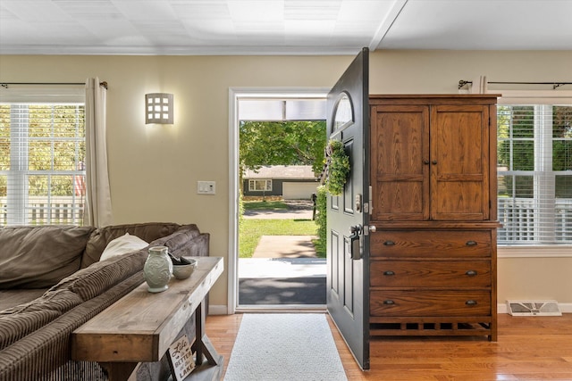 doorway to outside with light hardwood / wood-style floors and plenty of natural light