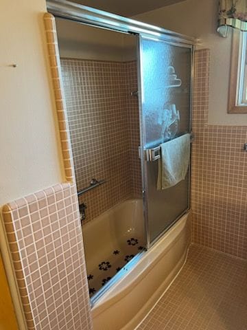 bathroom with tile patterned floors and enclosed tub / shower combo