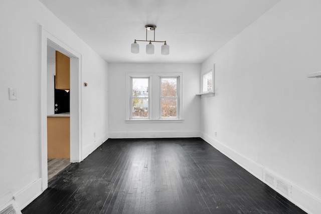 unfurnished dining area with dark hardwood / wood-style flooring