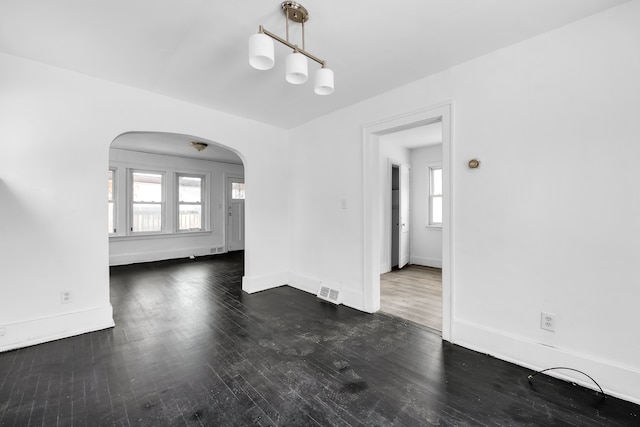 unfurnished dining area featuring dark wood-type flooring