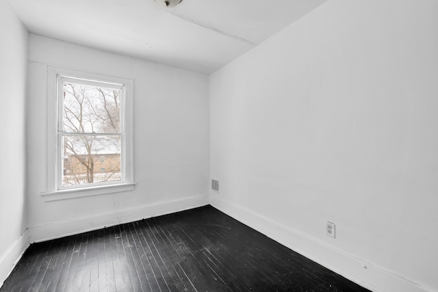 unfurnished room featuring dark hardwood / wood-style flooring