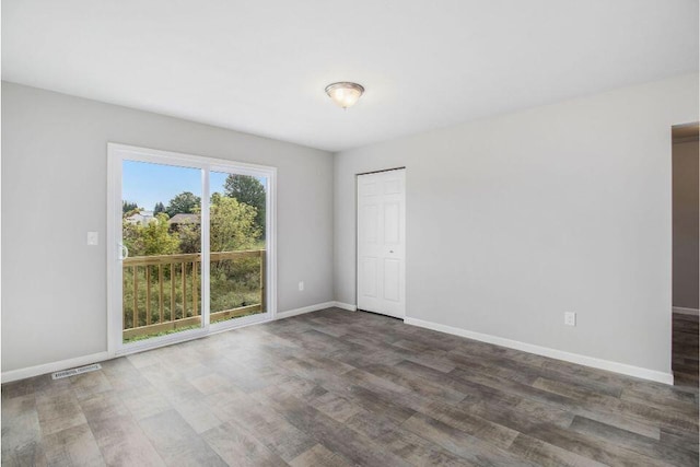 spare room with dark hardwood / wood-style floors