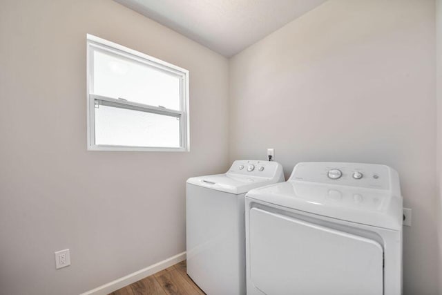 washroom featuring hardwood / wood-style floors and washing machine and dryer