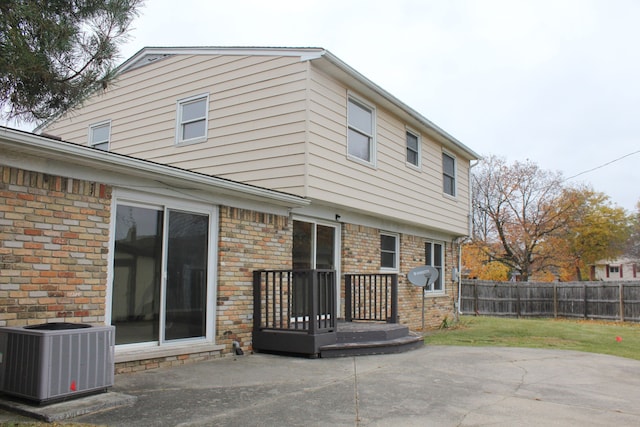 back of house with central air condition unit and a patio area