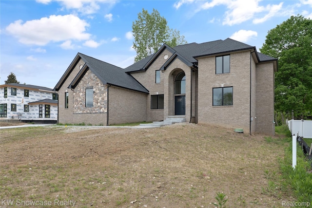 5245 Buell Dr, Commerce Twp, MI 48382 - french country home with brick siding and roof with shingles