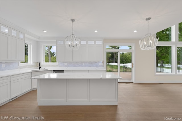 5245 Buell Dr, Commerce Twp, MI 48382 - kitchen with a chandelier, a sink, tasteful backsplash, and recessed lighting