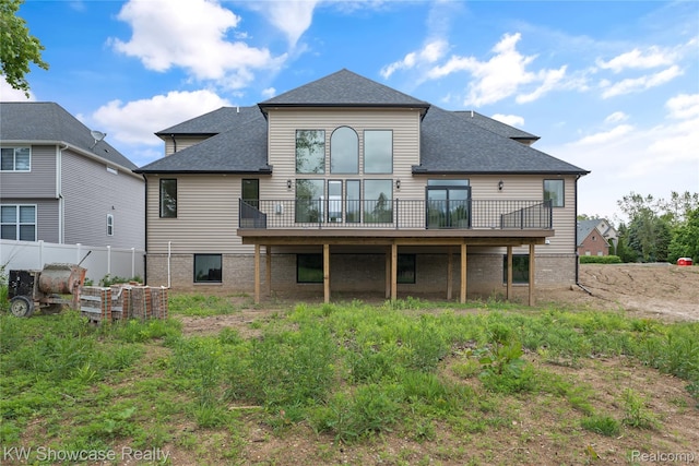 5245 Buell Dr, Commerce Twp, MI 48382 - rear view of house featuring a shingled roof and a deck