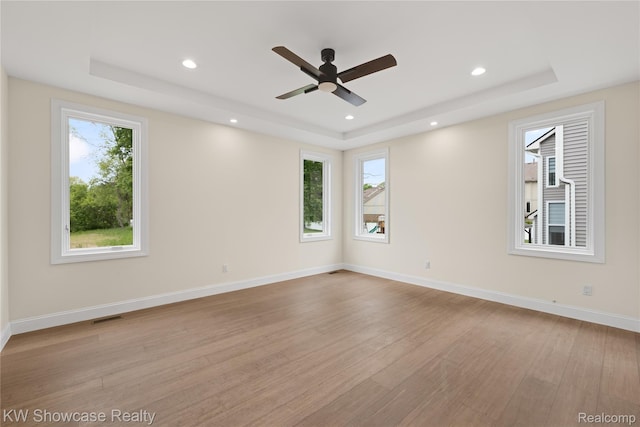 5245 Buell Dr, Commerce Twp, MI 48382 - unfurnished room with a tray ceiling, plenty of natural light, light wood-type flooring, recessed lighting, and ceiling fan