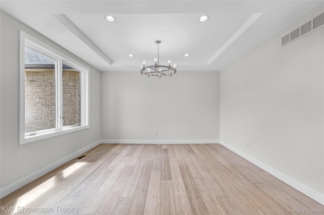 5245 Buell Dr, Commerce Twp, MI 48382 - unfurnished room with a chandelier, a tray ceiling, light wood-style floors, recessed lighting, and baseboards