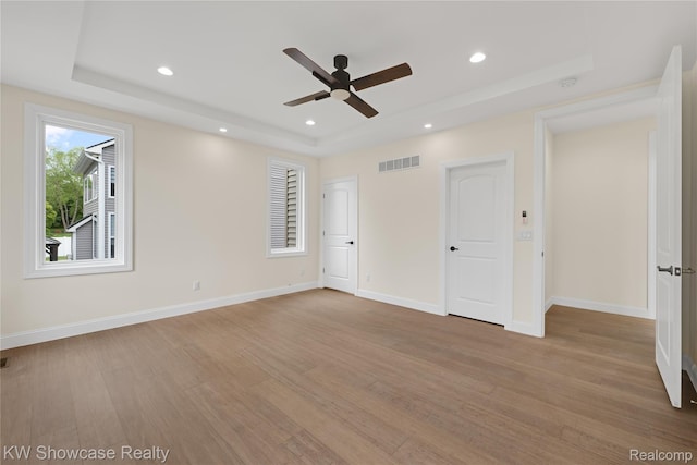 5245 Buell Dr, Commerce Twp, MI 48382 - spare room featuring a tray ceiling, wood finished floors, recessed lighting, ceiling fan, and baseboards