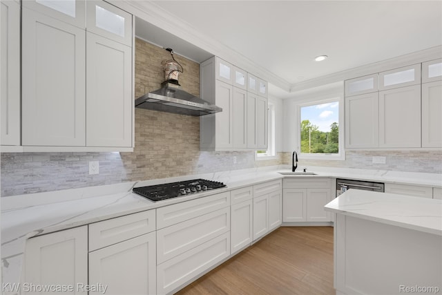 5245 Buell Dr, Commerce Twp, MI 48382 - kitchen featuring stainless steel gas stovetop, a sink, ornamental molding, white cabinets, and tasteful backsplash