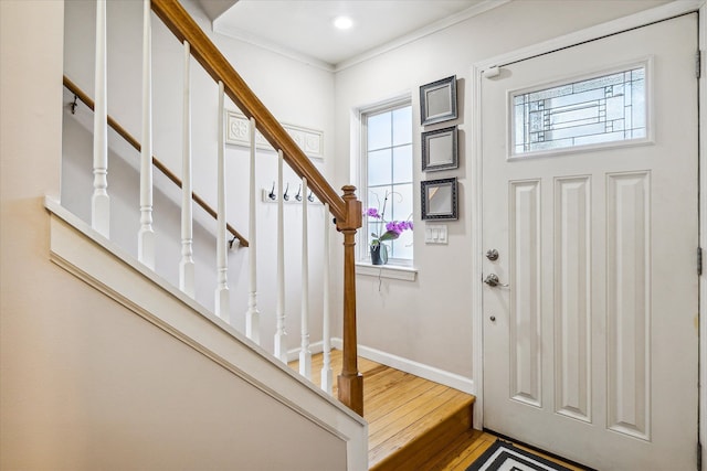 foyer featuring hardwood / wood-style floors and ornamental molding