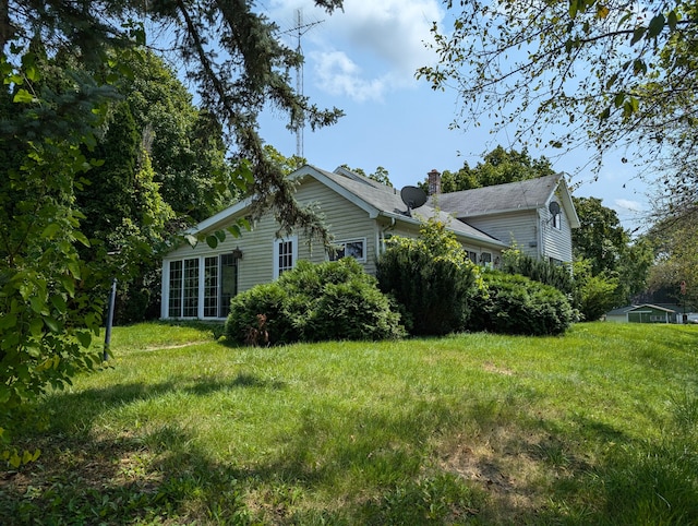 view of side of property with a yard