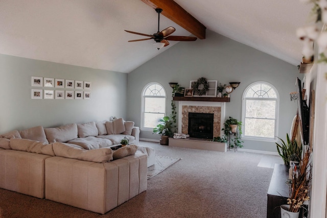 carpeted living room with ceiling fan and vaulted ceiling with beams