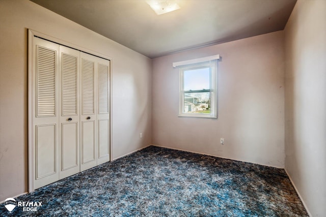 unfurnished bedroom featuring a closet and carpet floors