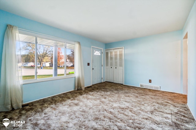 view of carpeted foyer