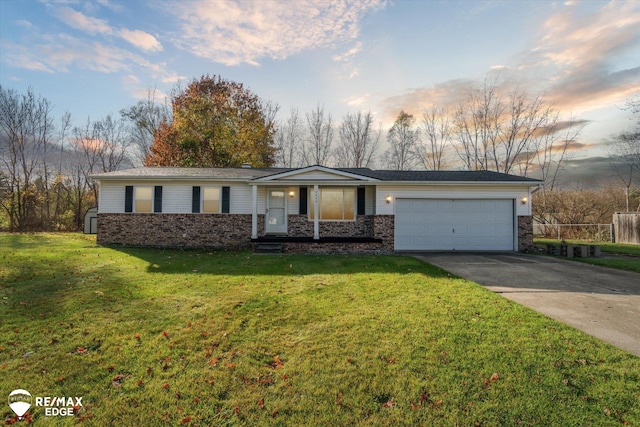 ranch-style home with a porch, a garage, and a yard