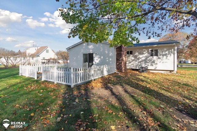 rear view of house featuring a lawn