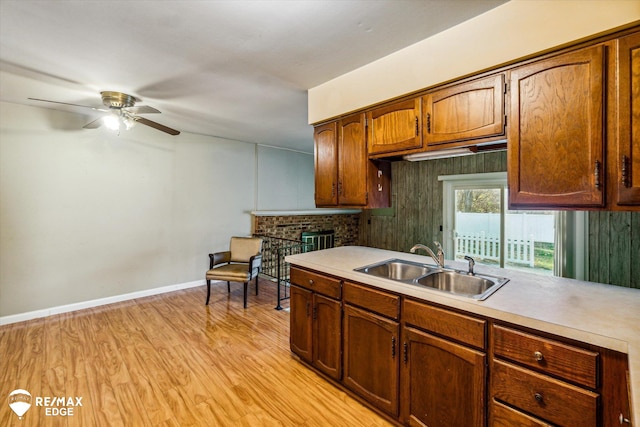 kitchen featuring light hardwood / wood-style floors, ceiling fan, and sink