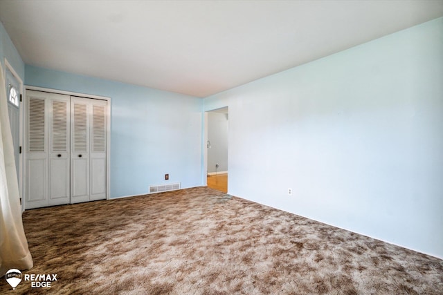 unfurnished bedroom featuring a closet and carpet floors