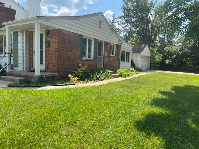 view of side of property with a lawn and a garage