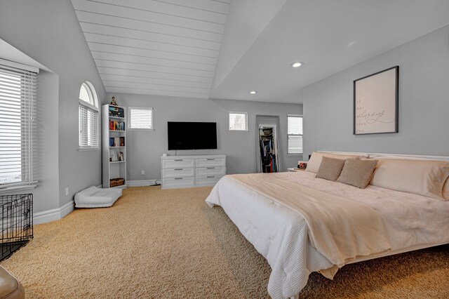 carpeted bedroom featuring multiple windows and lofted ceiling