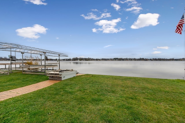 dock area with a water view and a yard