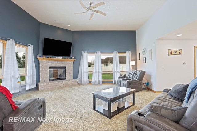 living room featuring carpet, a brick fireplace, and ceiling fan