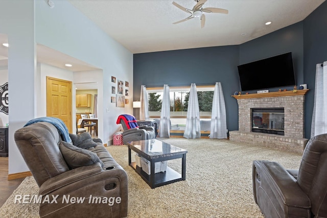 carpeted living room with ceiling fan and a brick fireplace