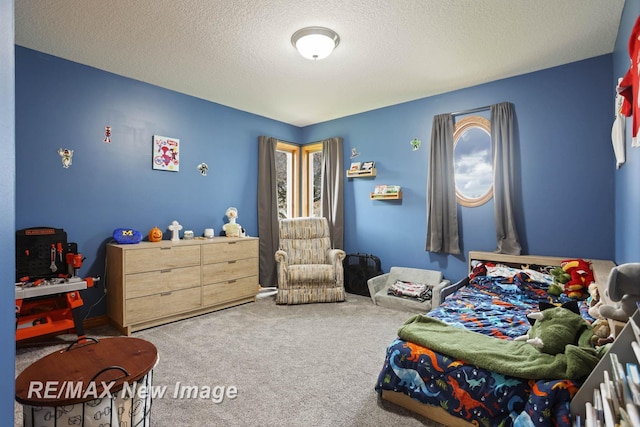 bedroom featuring carpet flooring and a textured ceiling