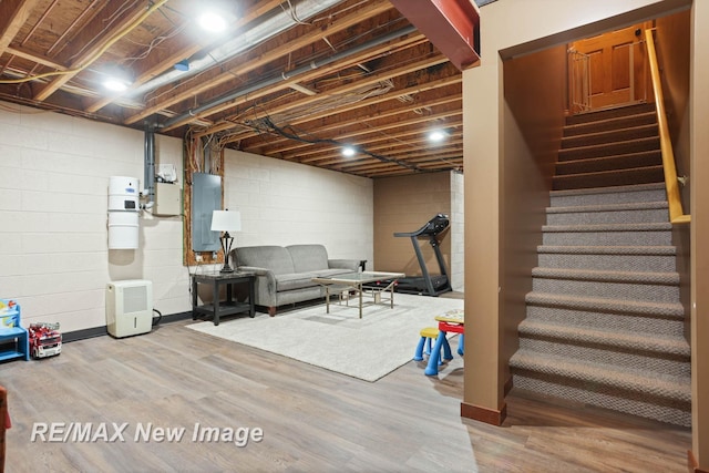 basement featuring hardwood / wood-style floors and electric panel