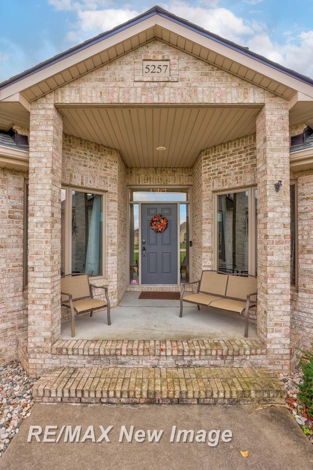 view of exterior entry featuring a porch