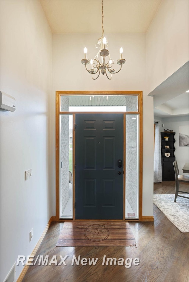 entrance foyer featuring hardwood / wood-style flooring and a notable chandelier