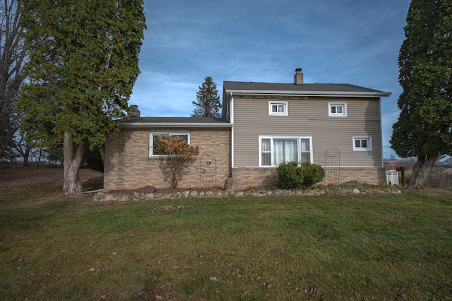 back of property featuring a lawn