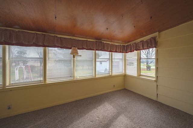 unfurnished sunroom with wood ceiling