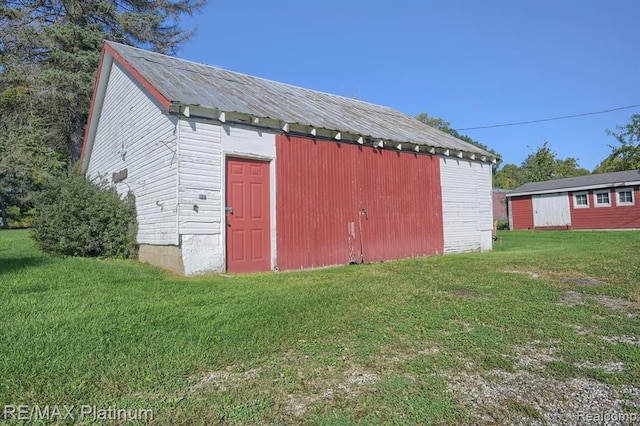 view of outbuilding featuring a yard