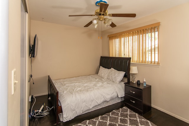 bedroom featuring ceiling fan and dark wood-type flooring