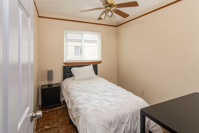 bedroom featuring ceiling fan, ornamental molding, and dark parquet floors