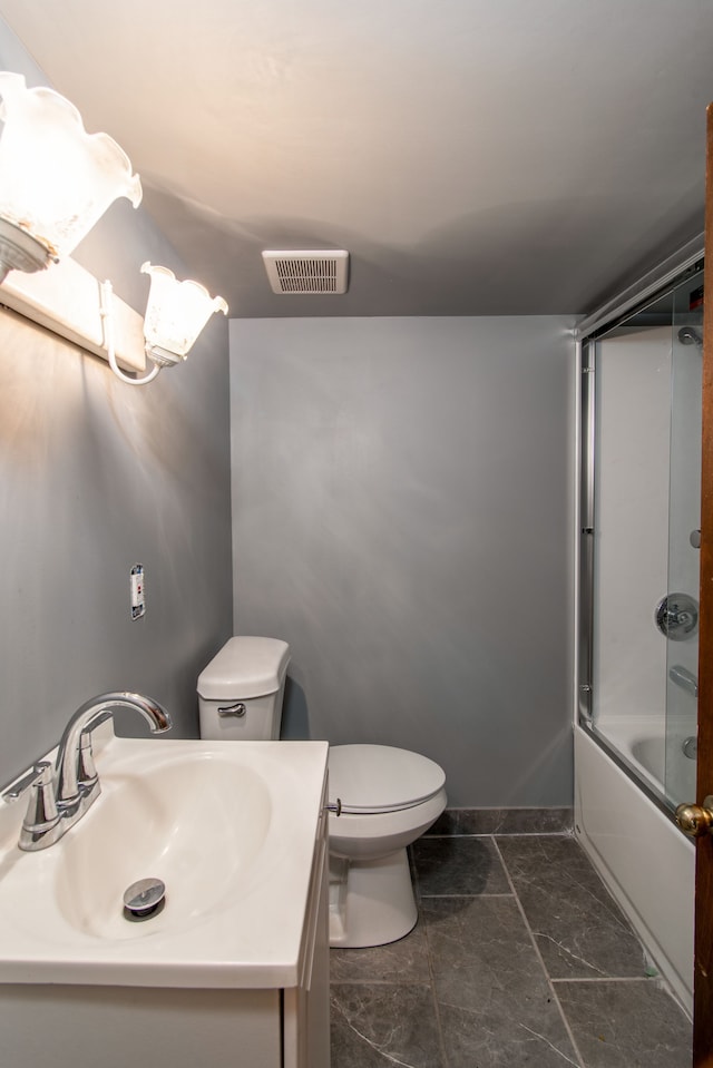 full bathroom featuring toilet, vanity, and combined bath / shower with glass door