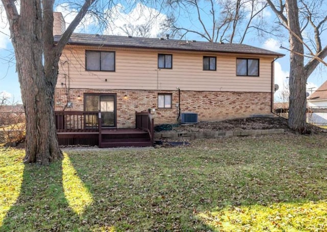 back of property featuring a lawn, cooling unit, and a wooden deck