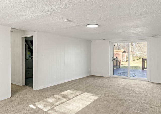 carpeted spare room with a textured ceiling