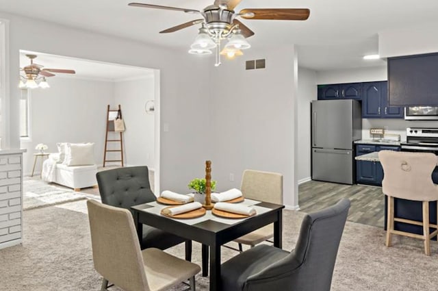 dining area with ceiling fan and light hardwood / wood-style floors