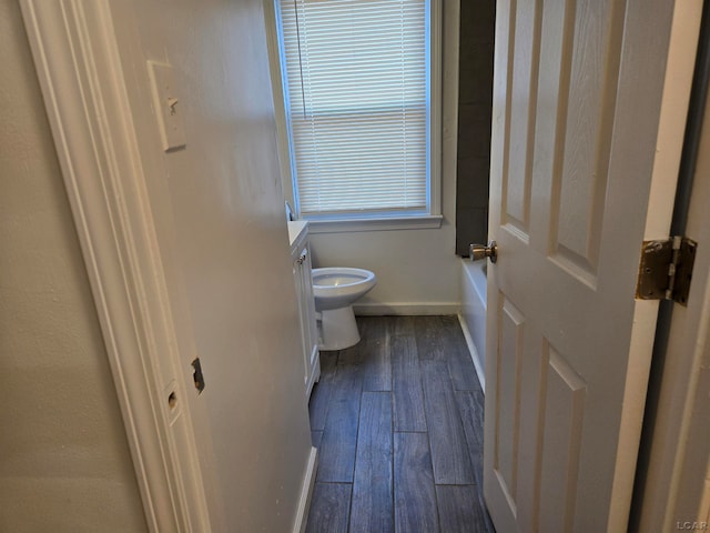 bathroom with hardwood / wood-style floors, vanity, and toilet