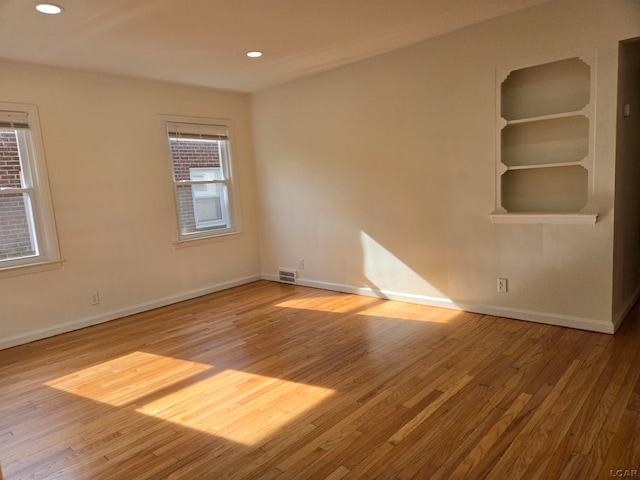 empty room with light hardwood / wood-style flooring