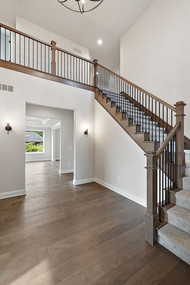 2166 Heidi Dr, Oxford, MI 48370 - stairs featuring wood finished floors, baseboards, a high ceiling, recessed lighting, and a chandelier
