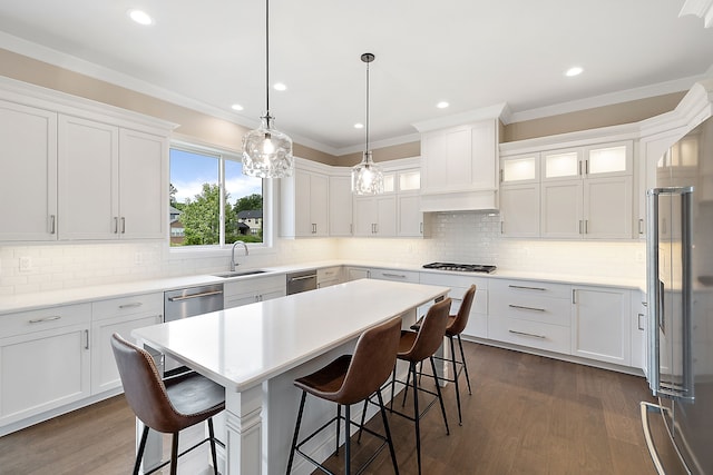 kitchen with white cabinets, dark hardwood / wood-style flooring, and ornamental molding