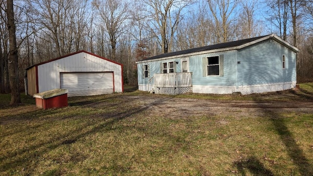 view of front facade with a garage, an outdoor structure, and a front lawn