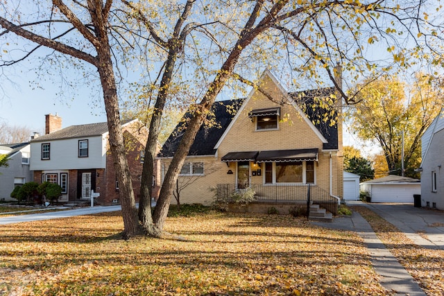 view of front of house with an outbuilding, a garage, and a front yard